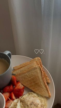 an egg, toast and strawberries on a white plate with a cup of coffee