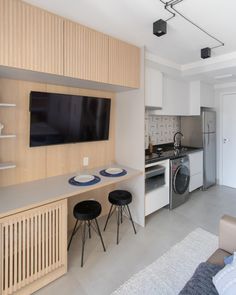 a kitchen and living room with a flat screen tv