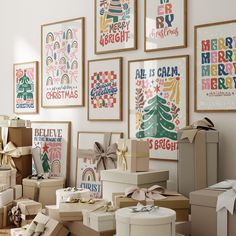 boxes and presents are stacked on the floor in front of christmas cards, posters, and gifts