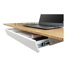 a laptop computer sitting on top of a wooden desk next to a drawer with files in it