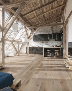 an open kitchen and living room with wood flooring, exposed beams and white brick walls