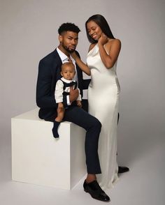 a man, woman and baby posing for a photo