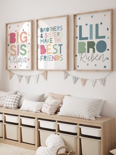 three framed pictures hang on the wall above a bench with storage bins underneath them