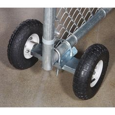 two wheels are attached to a metal fence