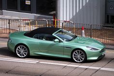 a green sports car parked on the side of the road