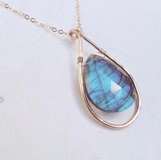 These Labradorite Necklaces are gorgeous! Faceted pear shaped rainbow Labradorite sparkle at every angle! These pendants are completed with a delicate hammered frame to add extra sparkle and flash. Perfect for that special someone who can't get enough of the irresistible colors that come from this stone in the sunlight!  The pendant measures about approximately an inch and a quarter long and an 3/4 of an inch wide.  These necklaces are available on 14k gold filled, gold toned stainless steel, St Labradorite Necklaces, Nature Inspired Jewelry, Beads And Wire, Wire Wrapped Pendant, Wire Wrapped Jewelry, Stainless Steel Chain, Pear Shaped, Pendant Necklaces, Labradorite