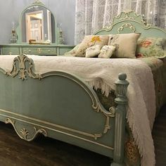 a bedroom with a bed, dresser and mirror