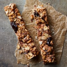 two granola bars sitting on top of a piece of parchment paper next to each other