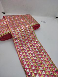 artisanal handcrafed geometric triangular gota patti embroidered carrat pink indian wedding sari costume border edging trimming by the yardWidth: 4.5 inchesThis lace ribbon trim can be used in :-dress edging, scarves and veils- traditional Indian outfits( saree, blouses, dupattas, kurti etc)-crafting headband, hats-table runner, curtains-jewelry making,-for making belt-floral arranging-waist belt to add grace plain outfit-trimming shrugs, skirts, tunics,-embellishing festive wear, wedding wear, Festive Pink Embroidered Fabric With Gota Work, Pink Festival Dupatta With Gota Work, Pink Embroidered Fabric For Festivals, Pink Embroidered Fabric For Festive Occasions, Pink Embroidered Fabric With Mirror Work For Diwali, Pink Dori Work Dupatta For Festival, Pink Dupatta With Mirror Work For Festival, Pink Embroidered Fabric With Dori Work For Party, Pink Border Dupatta For Diwali