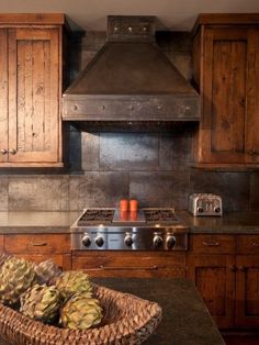 a basket filled with fruit sitting on top of a counter next to a stove top oven