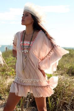 This is a fun & romantic tunic! This super soft boho chic tribal inspired cotton tunic dress / cover-up has embroidery and pom-poms details on the Spring V-neck Beach Dress With Tassels, V-neck Dress With Back Tassel Tie-up For Summer, Bohemian V-neck Kaftan For Spring, Spring Beach Cover-up Dress With Tassels, Bohemian Tunic Cover-up For Festivals, Flowy Hippie Summer Cover-up, Spring Kaftan With Tassel Ties, Spring Beach Cover-up Flowy Tunic, Spring Flowy Tunic For Beach Cover-up