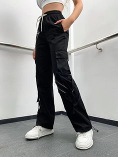 Make a fashion statement with these Zipper Detail Drawstring Cargo Pants. These pants feature a drawstring waist for a comfortable fit and zipper details that add a touch of edgy style. The combination of functionality and fashion makes them a versatile choice for various occasions. Whether you're going for a casual or street-style look, these zipper detail drawstring cargo pants will elevate your outfit. Specifications: Style: Casual Type: Cargo Pants Details: Drawstring, Pocket, Zipper Waist L Techwear Cargo Pants With Zipper For Streetwear, Sporty Streetwear Pants With Zipper Closure, Trendy Streetwear Cargo Pants With Zipper Closure, Casual Pants With Zipper Pocket For Fall, Casual Black Pants With Zipper Pocket, Trendy Streetwear Cargo Pants With Zipper, Casual Fall Pants With Zipper Pocket, Trendy Black Pants With Zip Fly, Trendy Black Bottoms With Side Zipper