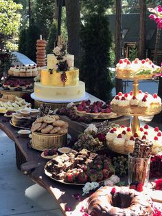 a table filled with lots of different types of cakes and desserts on top of it