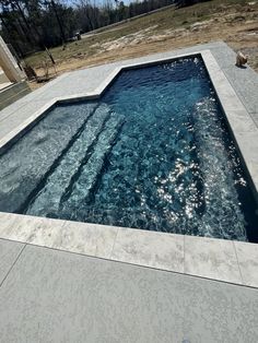 an empty swimming pool with clear blue water