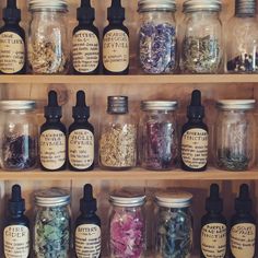 jars filled with different types of flowers and herbs