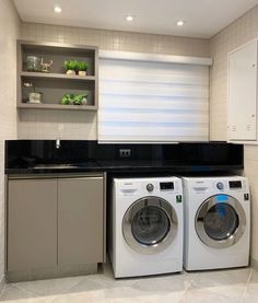 a washer and dryer sitting in a kitchen next to each other on top of a counter