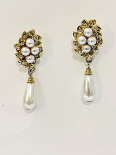 "Vintage Faux Pearl Rhinestone Earrings Drop Dangle Stiletto Earrings Wedding Victorian Pierce Post Gold-tone Earrings Formal Costume Jewelry Super Cute Earrings you can give as a gift to yourself or someone else  Condition: Good Condition  Measurements:    2\" length   2\" drop Check out the earring section of the shop for my vintage jewelry and treasures.  ------------------------------------------------------------ Be sure to check out shop for more retro gifts.  Add to your jewelry collectio Jeweled Metal Crystal Earrings For Wedding, Wedding Crystal Pearl Drop Earrings, Elegant Jeweled Teardrop Dangle Earrings, Formal Bridal Earrings With Rhinestones, Glamorous Metal Clip-on Earrings For Wedding, Formal Crystal Earrings With Pearl Drop, Formal Teardrop Metal Bridal Earrings, Elegant Jeweled Metal Clip-on Earrings, Formal Jeweled Drop Clip-on Earrings