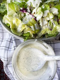 a salad with dressing in a bowl next to it