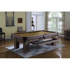 a pool table in the middle of a living room