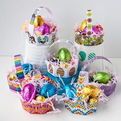 several baskets filled with different types of easter eggs and decorations on top of each other