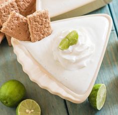 lime and key limes are on the table next to two plates with food in them