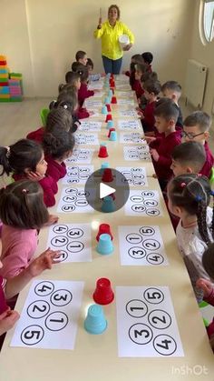 a group of children sitting at a long table