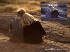 two people sitting on top of a large rock