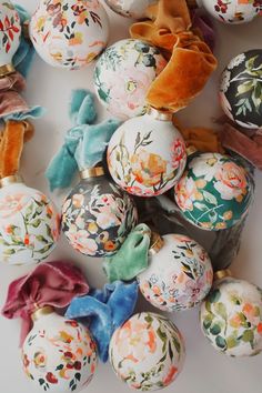 an assortment of painted eggs with bows on them