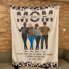 a blanket with three people standing next to each other and the words mom on it