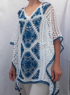 a woman wearing a blue and white crochet top