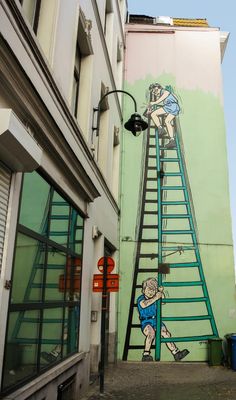 a mural painted on the side of a building depicts a man climbing up a ladder