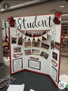 a bulletin board with pictures on it that says student and is decorated with red roses