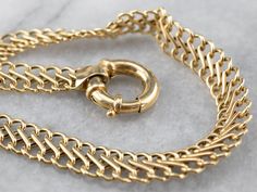 This chain bracelet is classic with a twist! Made up of woven infinity links, the 18-karat gold chain has a high polish that catches the light beautifully. A true wardrobe staple, this bracelet is versatile and easy to layer with your favorite pieces.Metal: 18K Yellow GoldWidth: 7.0 mmLength: 8 InchesMarks: "U56" Stamped on the clasp Gold-tone Chain Link Gold Bracelet With Box Chain, 14k Gold-filled Link Chain Bracelet, Luxury Gold-tone Chain Bracelet With Polished Finish, Gold-tone Brass Chain Link Bracelet, Luxury Gold-tone Polished Finish Chain Bracelet, 18k Gold Bracelet, Layered Bracelets, Wardrobe Basics, Wedding Bracelet