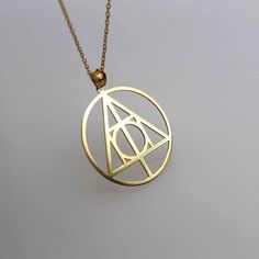 Philosopher's Stone 14k 18k Real Gold Necklace Pendant - Geometric Symbol ▶ 14K Solid Gold (585) ▶ 18K Solid Gold (750) ▶ Options: White,Rose,Yellow ▶ You can buy this necklace without chain. ABOUT NECKLACE Handmade with 14k/18k solid real gold. You can order this  Philosopher's Stone gold  necklace with 3 different color options, 5 different necklace length options and free & express shipping to the all-around the world. What is 14k Gold? 14K gold is a mixture which primarily consists of gold that is blended with durable metals such as zinc, nickel, and copper. Gold by itself is relatively soft, so the alloy metals are to strengthen the composition. 14 Karat specifically refers to the metal mixture that is 58.5% gold. To understand whether it is made with 14K gold or not, you can look for Gold Pendant Necklace, Symbolic Style, Metal Pendant Jewelry With Gold-tone Logo Plaque, Formal Gold-tone Logo Pendant Jewelry, Stone Gold Necklace, Luxury Gold-tone Logo Plaque Pendant Jewelry, Metal Pendant Necklace With Gold-tone Logo Plaque, Gold Necklace Pendant, Real Gold Necklace, Philosopher's Stone