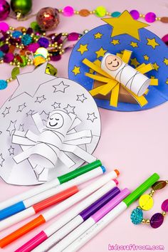 two paper plates and markers on a table with other crafting supplies including pens, crayons, and ornament shapes