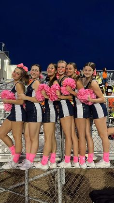 a group of cheerleaders standing next to each other