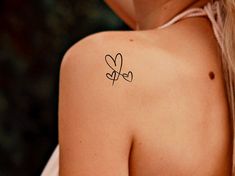 a woman with a tattoo on her shoulder