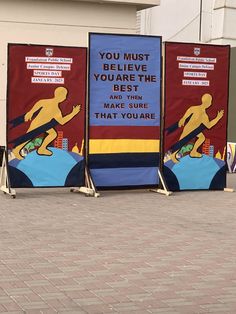 three signs on the side of a building advertising skateboarders and riding their boards