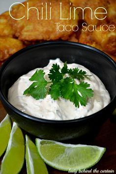 a black bowl filled with taco sauce and garnished with cilantro