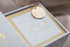 a close up of a box with a necklace on it's side and a card in the middle