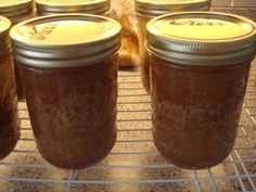 four jars of peanut butter sitting on a rack