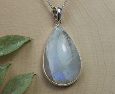 This is a beautiful Rainbow Moonstone from India set in Sterling Silver. This amazing stone has a unique look to them that you will not see with any other stone! It has a milky color that has flashes of blues, purples and some yellows when the light hits them in the right places, just like a Rainbow! This stone has a nice luster due to the cabochon roundness.  This larger 32mm X 21mm Pear Rainbow Moonstone weigh 22.65cts and will go great with most styles or occasions. Check out our Cabochon Stud Earring section for our matching 6mm Rainbow Moonstone Stud Earrings! A Cabochon gemstone is rounded and polished instead of having many facets. If you have any questions, please feel free to ask! Handmade White Moonstone Gemstones, White Moonstone Gemstones As Gift, White Moonstone Gemstones For Gift, White Moonstone Gemstones With Spiritual Style, Spiritual White Moonstone Gemstones, Rainbow Moonstone Pendant, Moonstone Pendant, Beautiful Rainbow, Rolo Chain