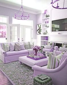 a living room filled with lots of purple furniture