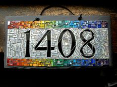 a house number sign made out of stained glass with the number forty8 on it