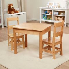 a child's wooden table and chairs in a room