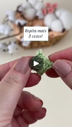 someone crocheting the end of a piece of yarn with their fingers and thumbnails