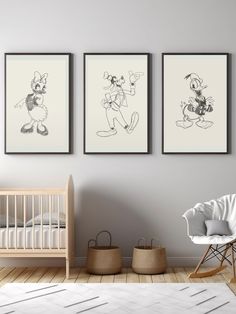 three framed mickey mouses on the wall in a baby's room