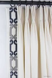 the curtains are hanging on the wall with black and white trimmings, along with a name tag that says lynn clark