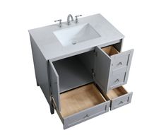 a bathroom vanity with two drawers and a sink in the bottom drawer that is open