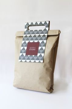 a brown paper bag with a red tag on the front and bottom, sitting against a white background